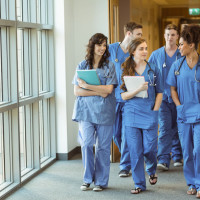medical residents walking down a hospital hall