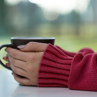 Associations of Coffee, Tea, and Caffeine Intake with Coronary Artery Calcification and Cardiovascular Events woman holding a hot drink